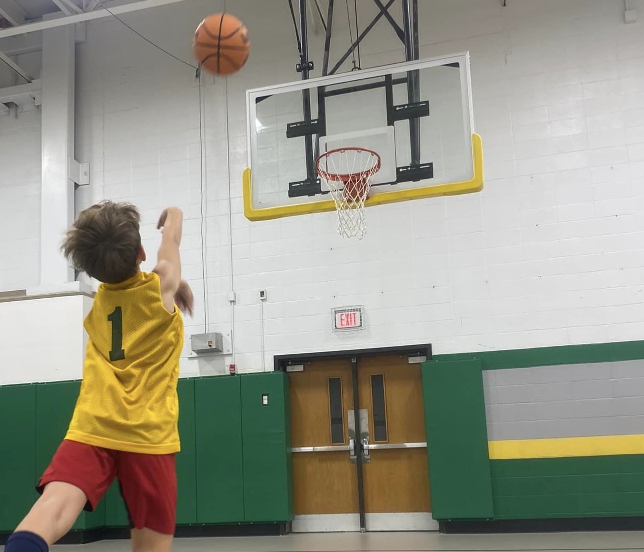 Lindbergh basketball clinic with a player shooting