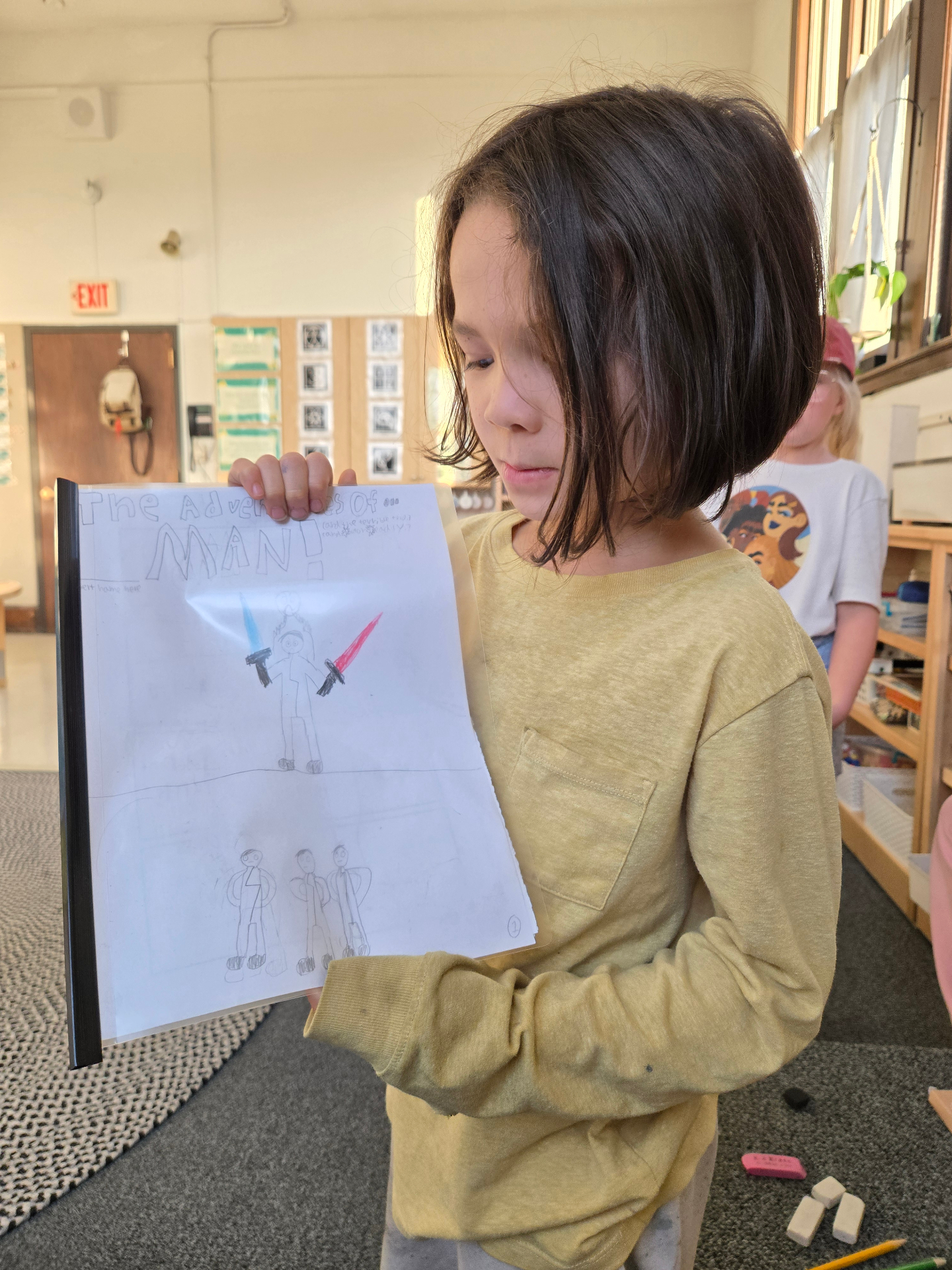 Student showing off a finished comic book project