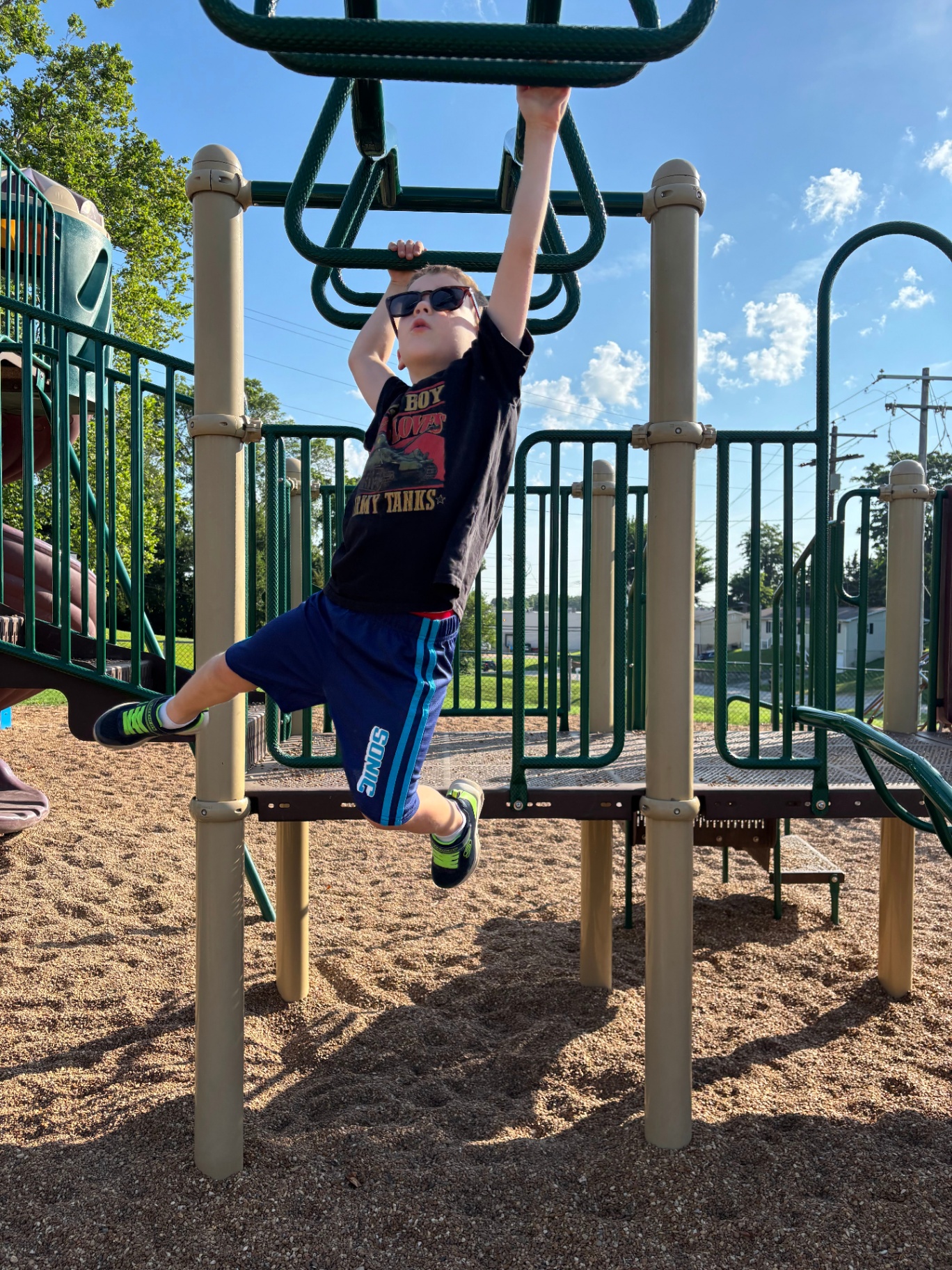 Camper crossing the monkey bars at a Recreation Academy Playground Champions Camp