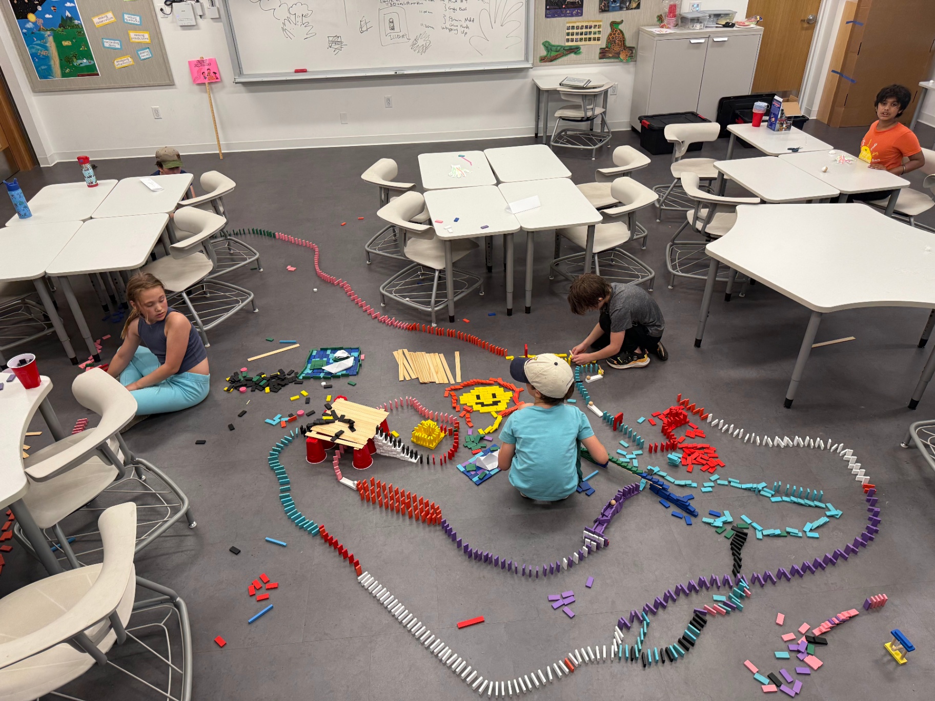 Kids building a massive domino course during a Recreation Academy STEM club