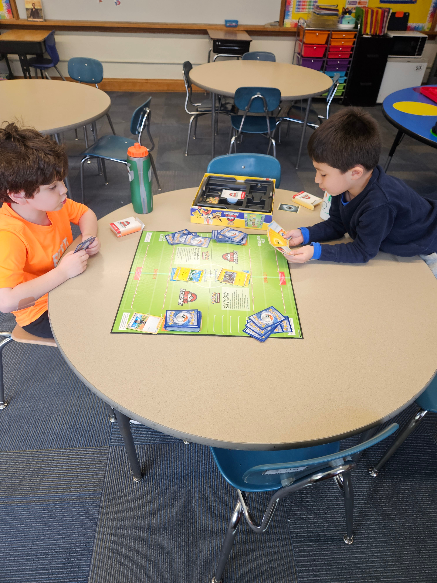 Kids trading Pokémon cards at a Recreation Academy club