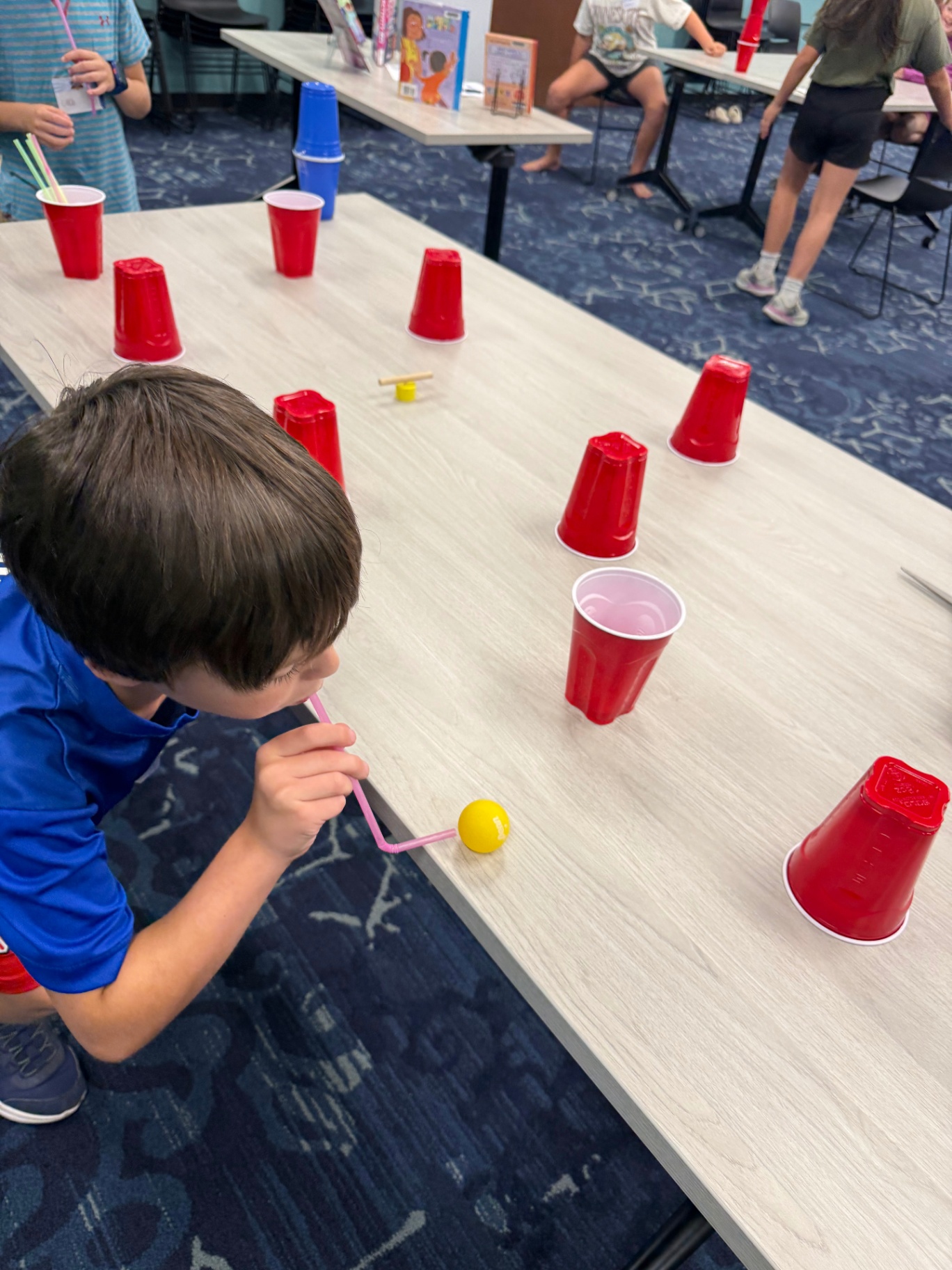Kids competing in a minute-to-win-it challenge game